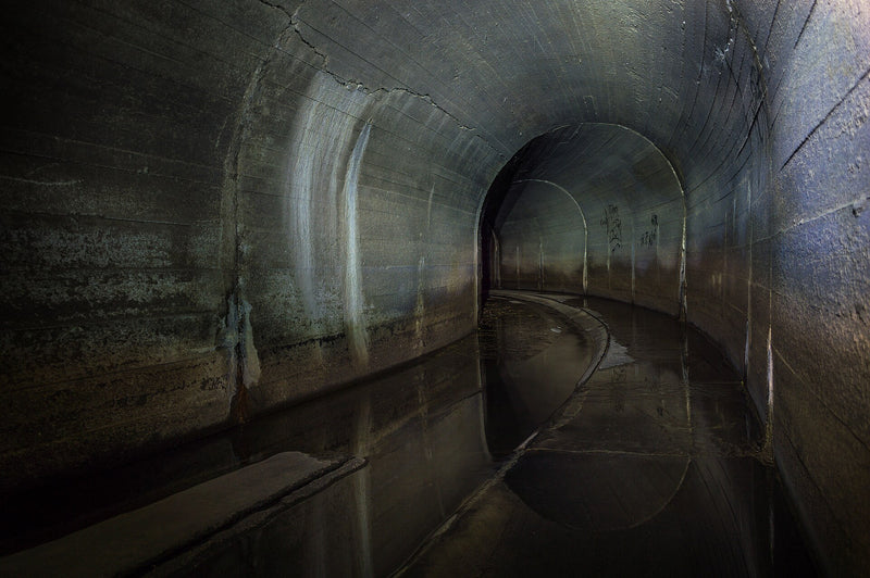 Inside a dry concrete storm drain tunnel