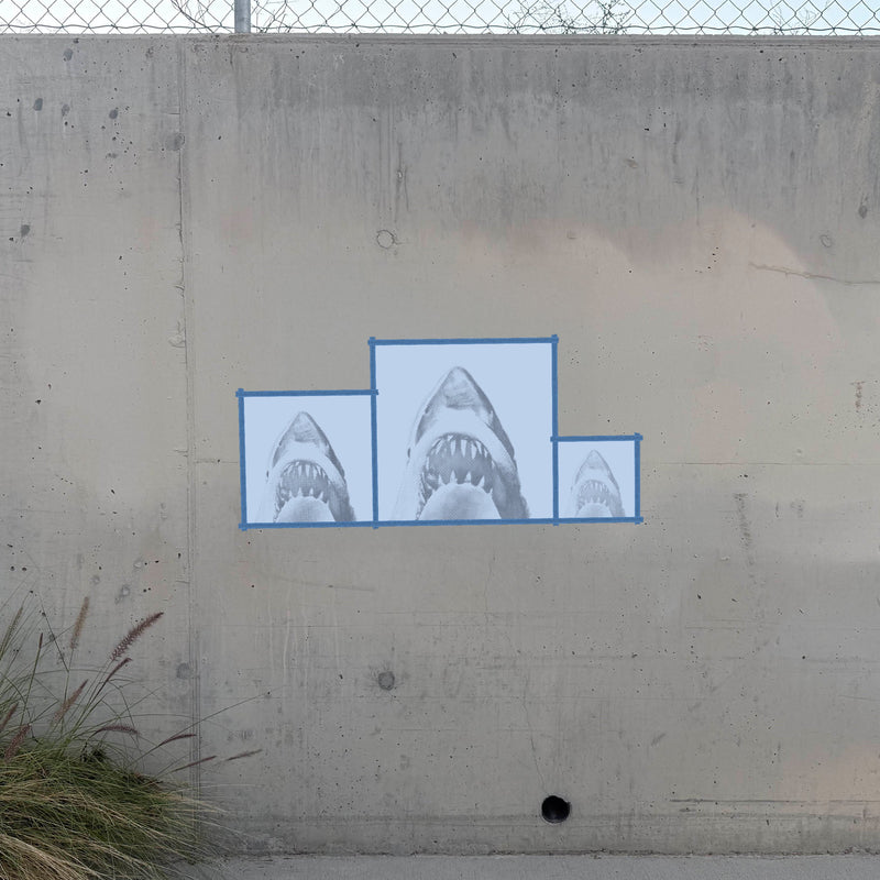 Jaws halftone stencil sprayed on a concrete wall