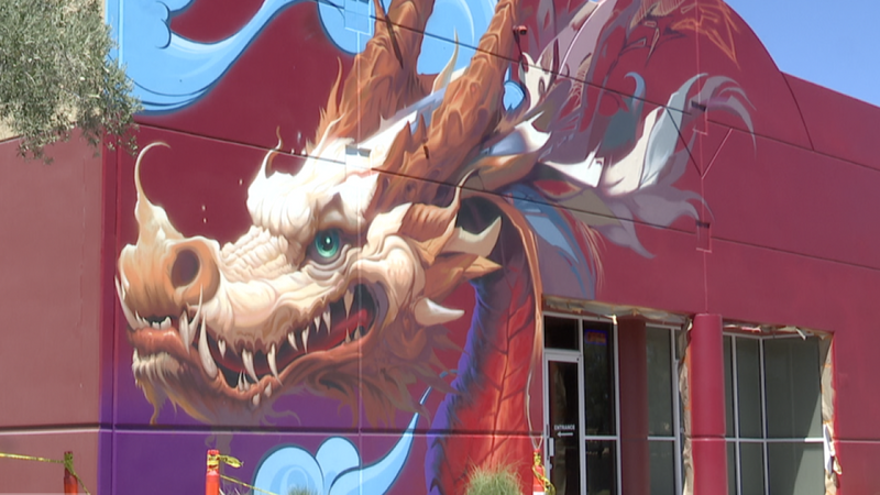 A gold and cream dragon mural painted on a red building at the Golden Dragon Shopping Center in Las Vegas Chinatown