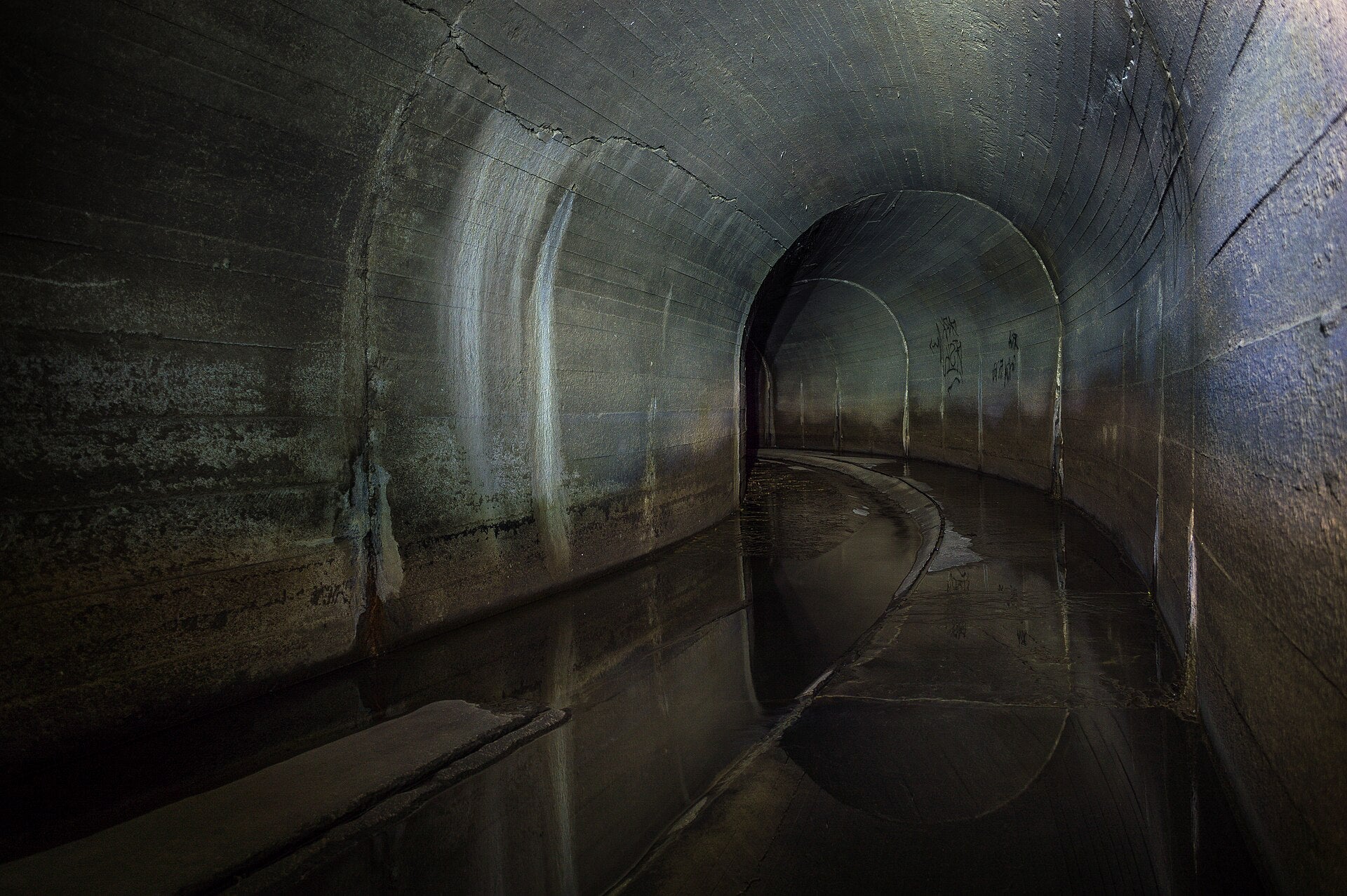 Inside a dry concrete storm drain tunnel