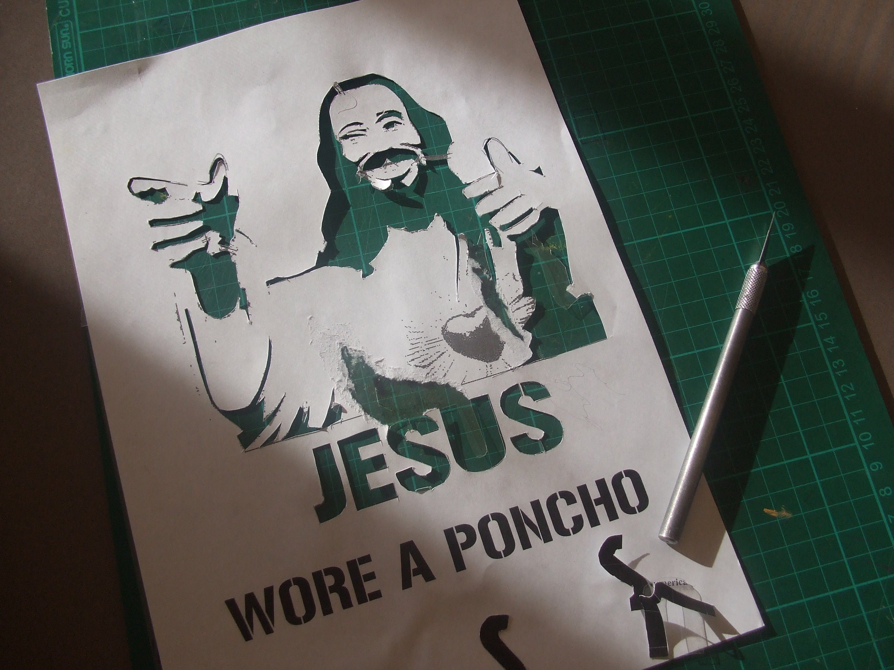 Stencil being hand-cut with a blade showing the halftone dot cutting process