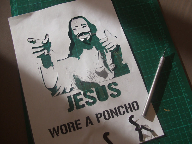 Stencil being hand-cut with a blade showing the halftone dot cutting process