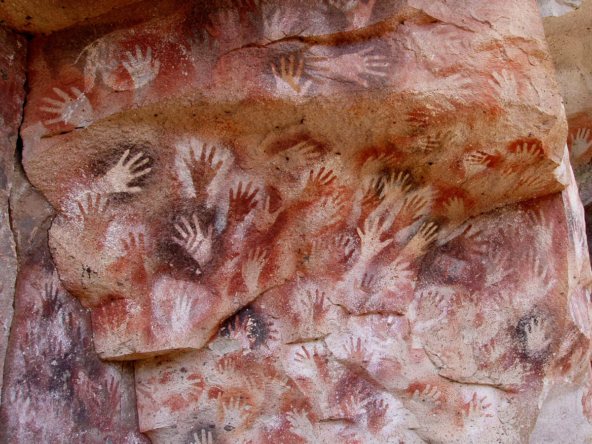 Wall of negative hand stencils at Cueva de las Manos, Argentina