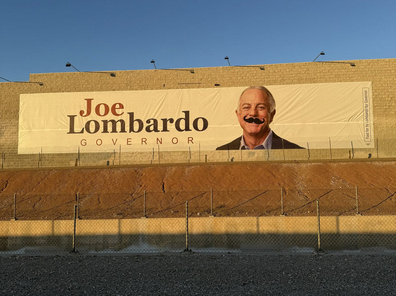 Governor Joe Lombardo campaign banner with a mustache added, Las Vegas