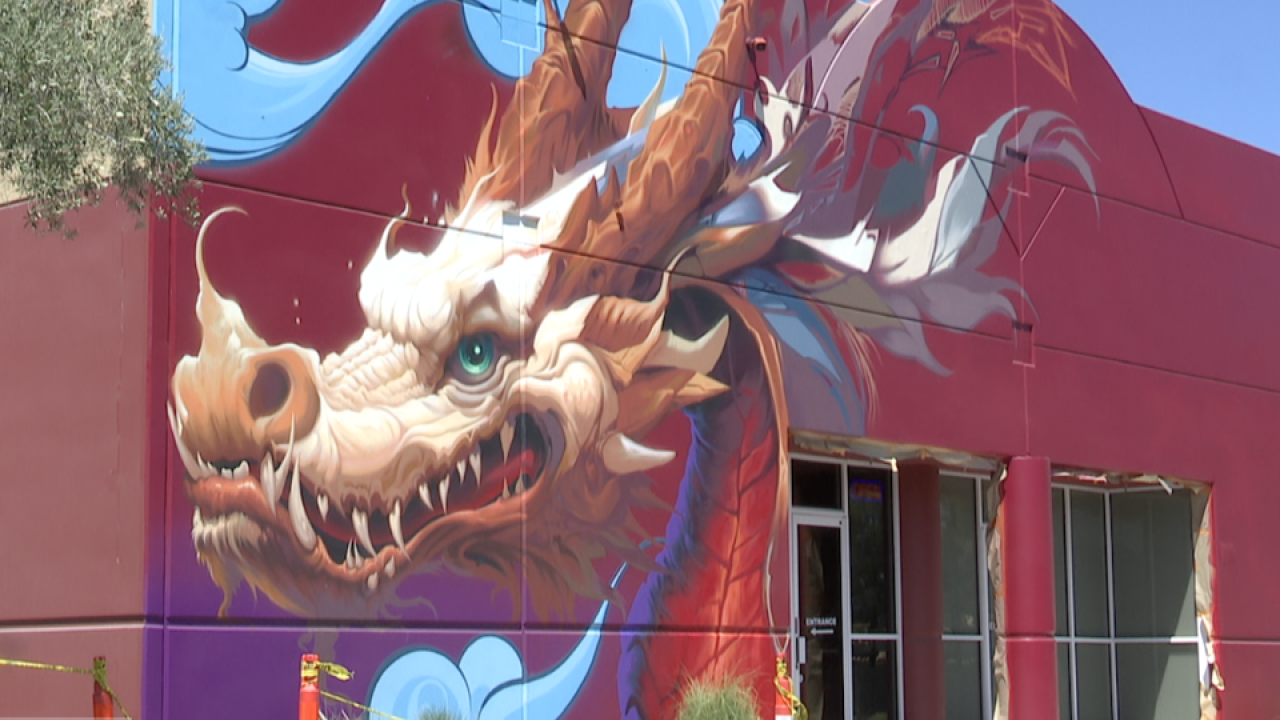 A gold and cream dragon mural painted on a red building at the Golden Dragon Shopping Center in Las Vegas Chinatown