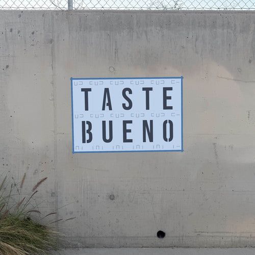 Bebas Neue Font Stencil Pack letter stencils latched together on a wall spelling TASTE BUENO